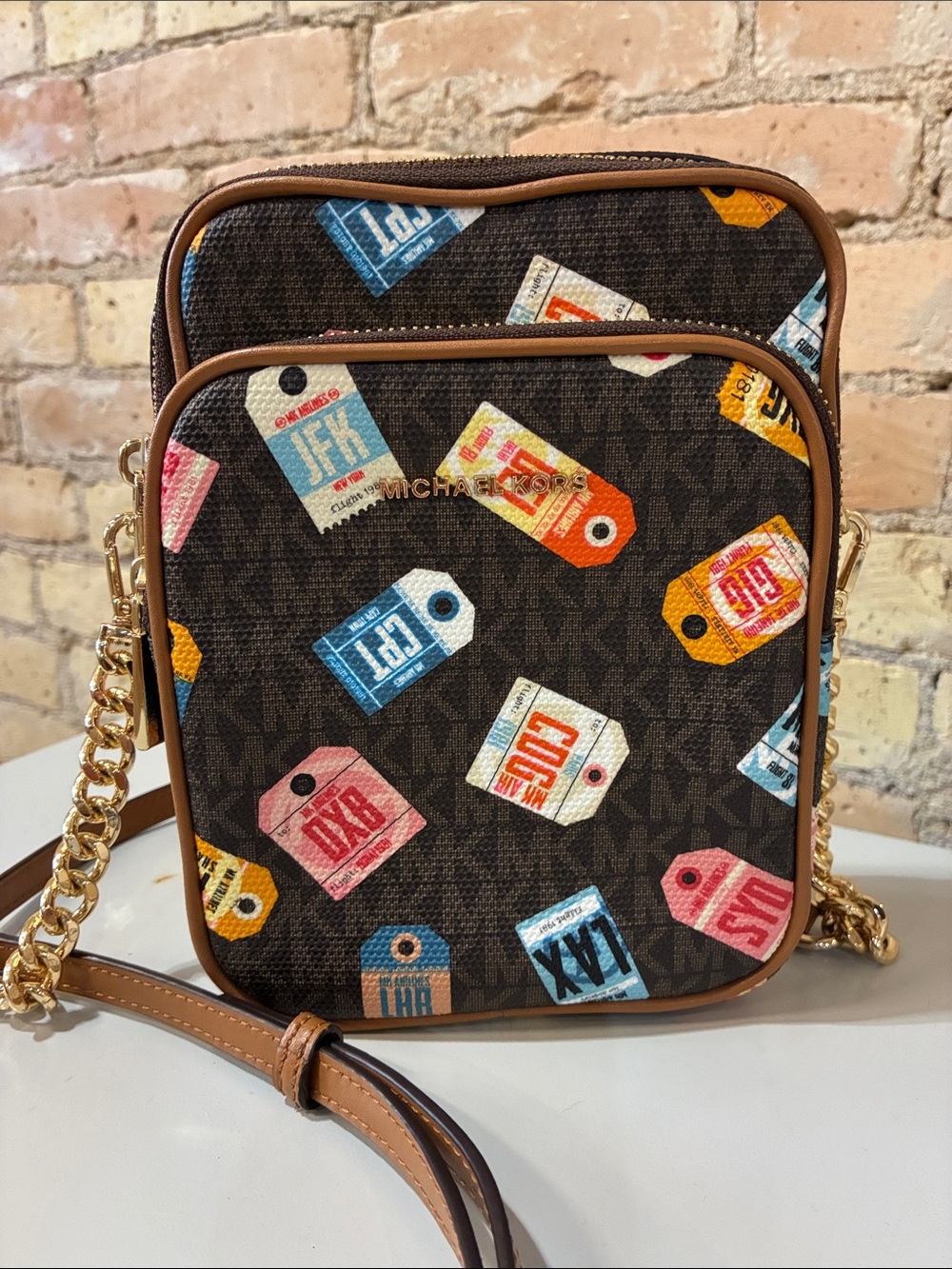 Michael Kors Jet Set Smartphone Crossbody with Multicolor Luggage Tag Print.